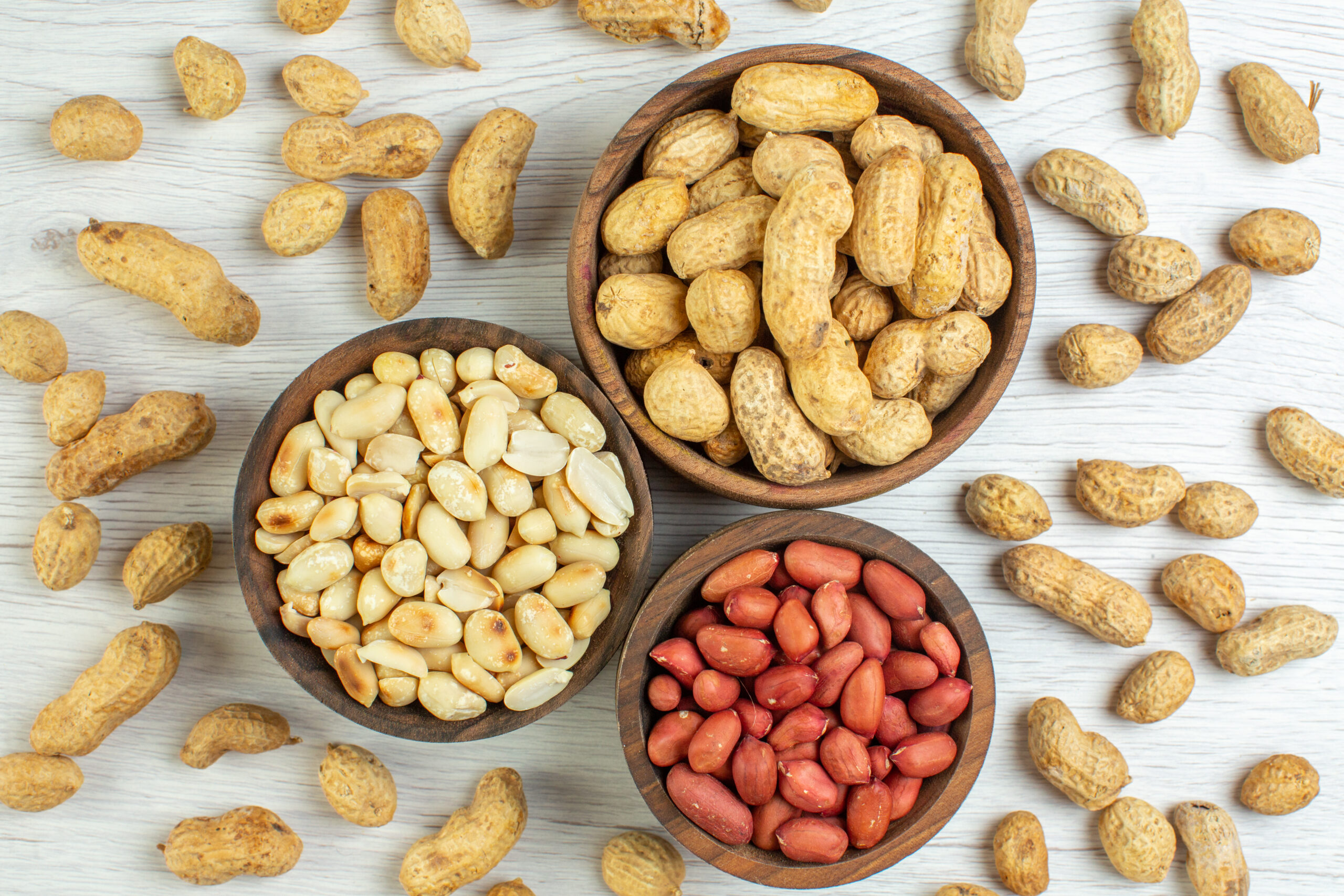 top-view-fresh-peanuts-white-table